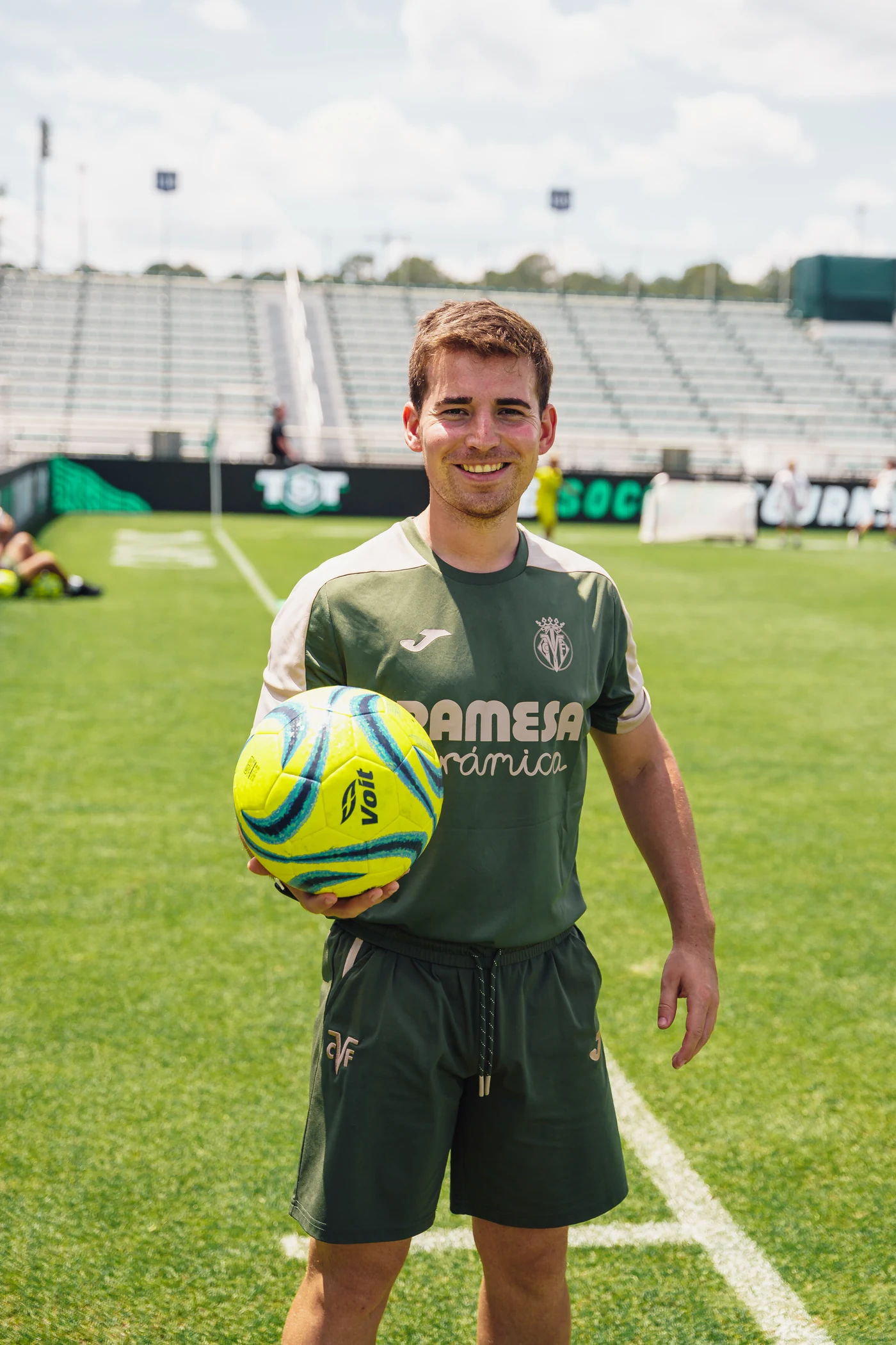 Villarreal team member holding a soccer ball on the pitch at TST 2026